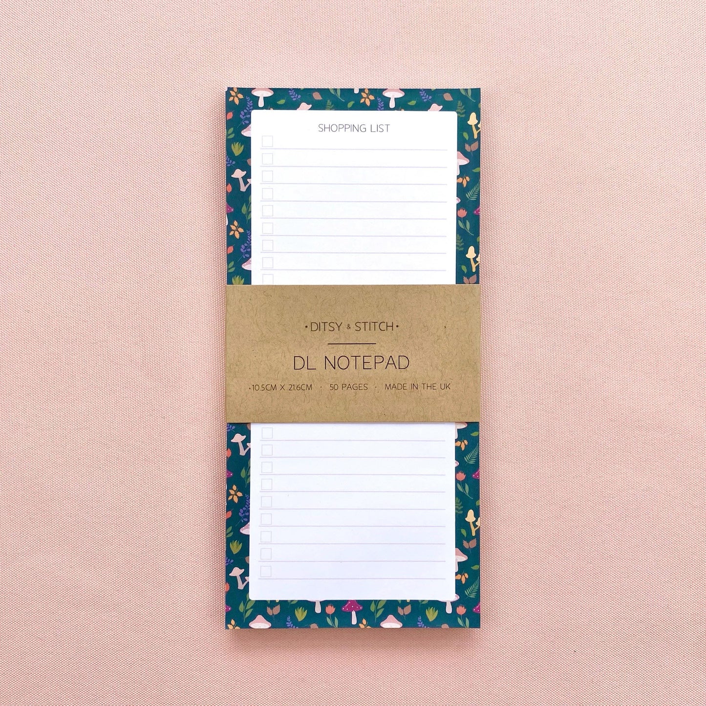 Autumn foliage-patterned shopping list notepad on a pink background