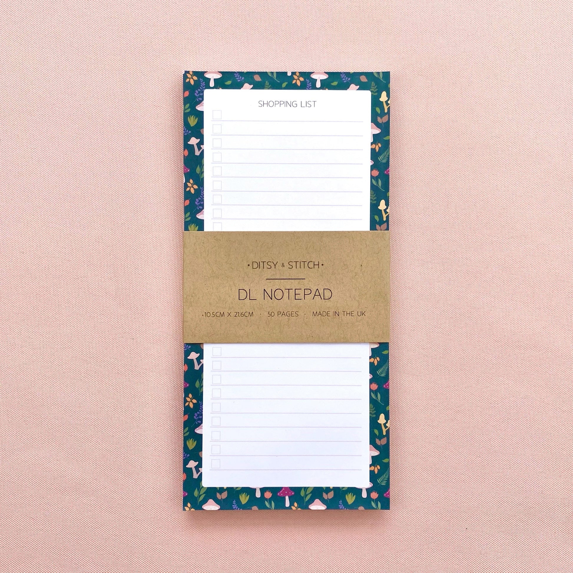Autumn foliage-patterned shopping list notepad on a pink background