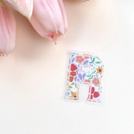 Letter 'R' sticker with floral design on a white background