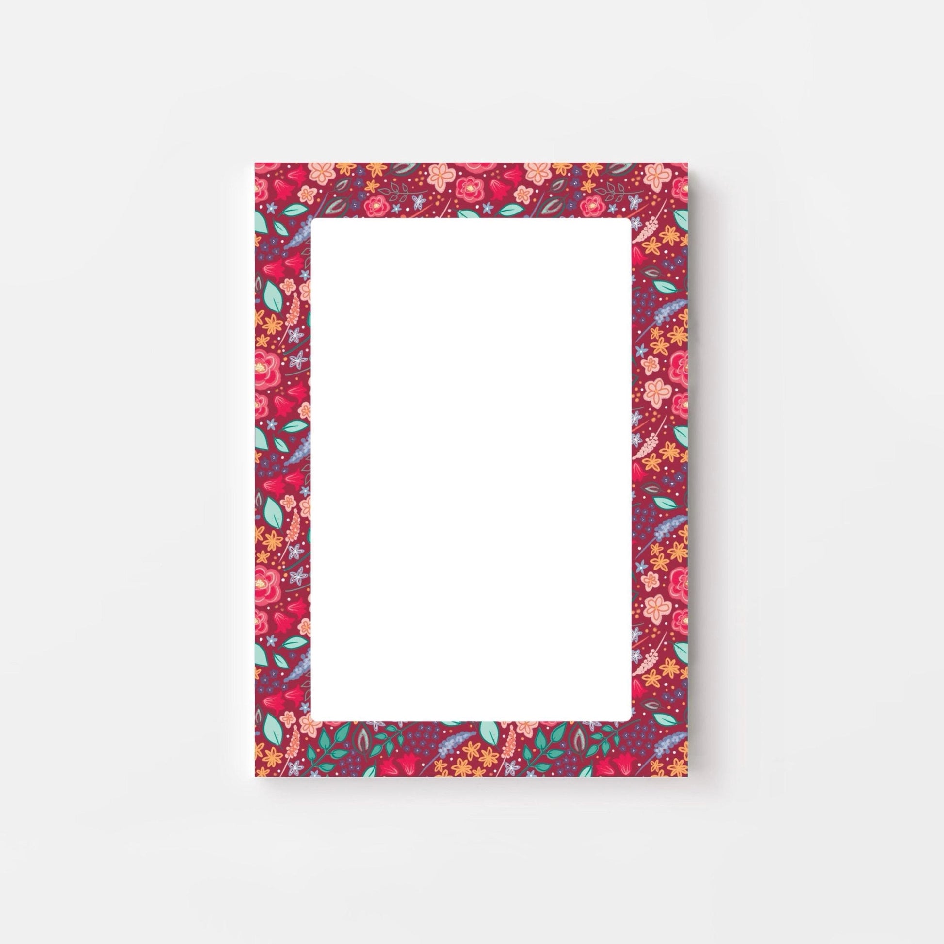 Pink floral patterned bordered notepad on a white background