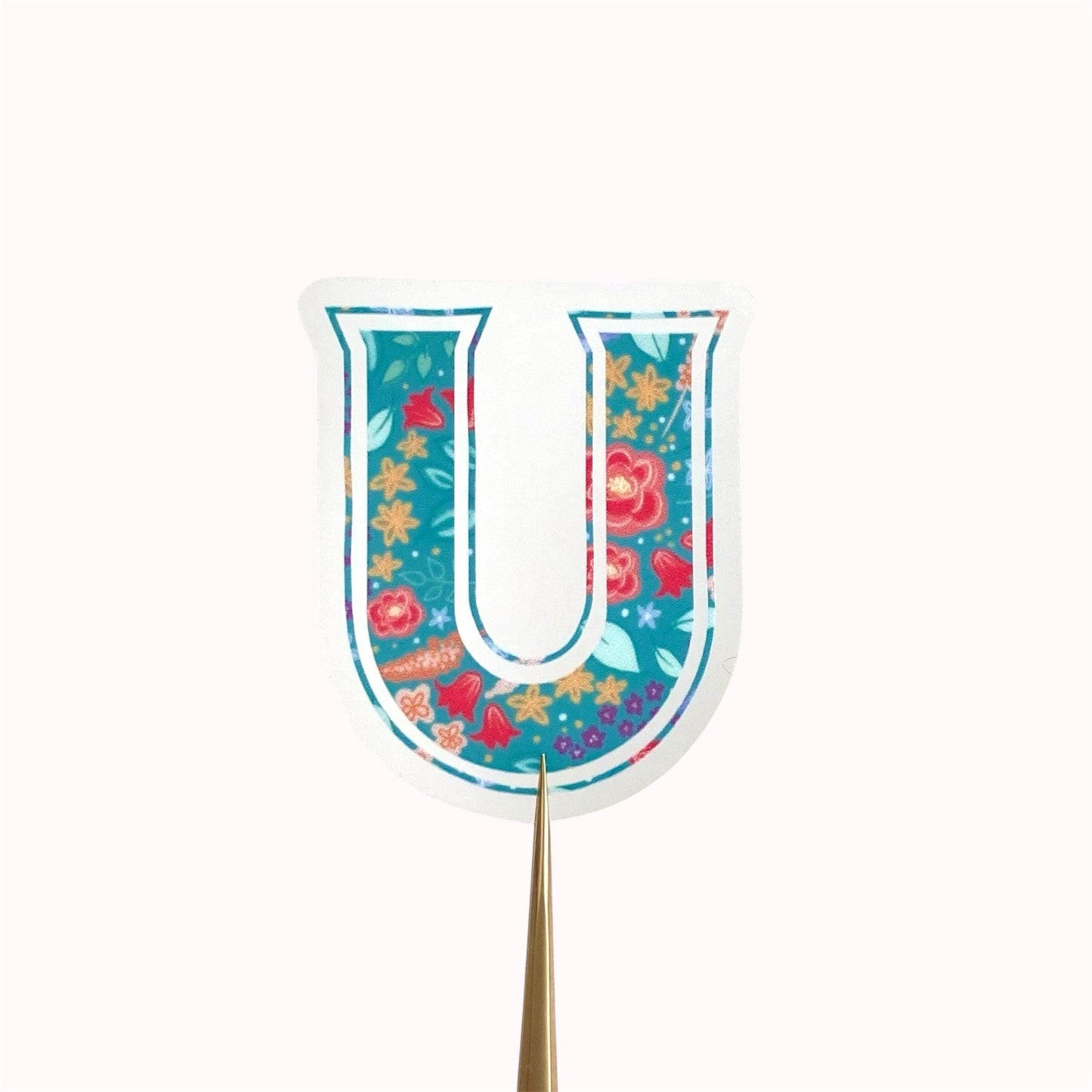 Decorative letter 'U' sticker with floral pattern on a white background