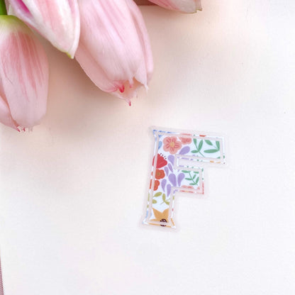 Floral letter 'F' clear sticker against a white background.