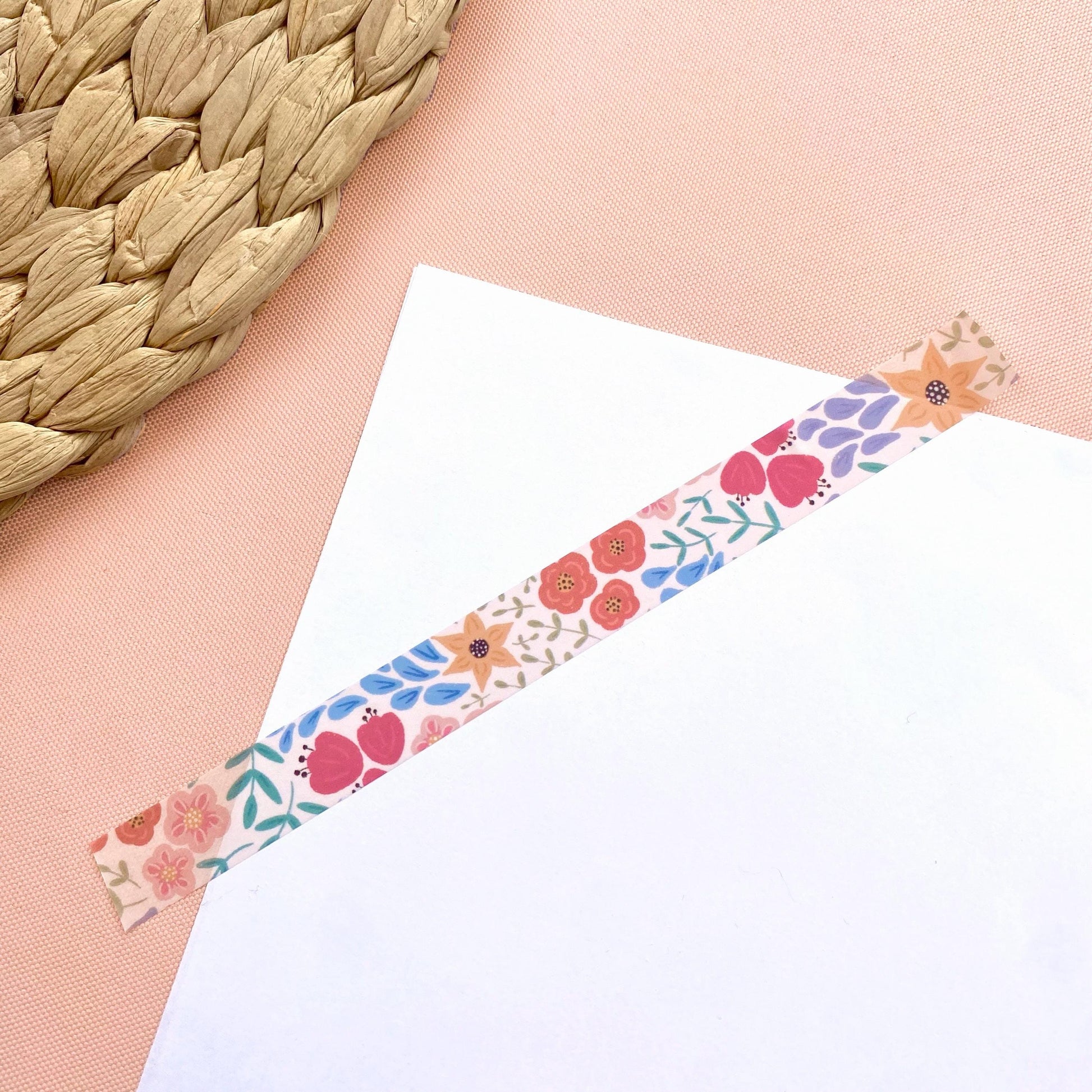 Floral decorative tape on a white card with a woven mat background