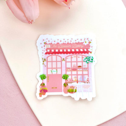 Sticker of a pink bakery with decorative elements on a white background