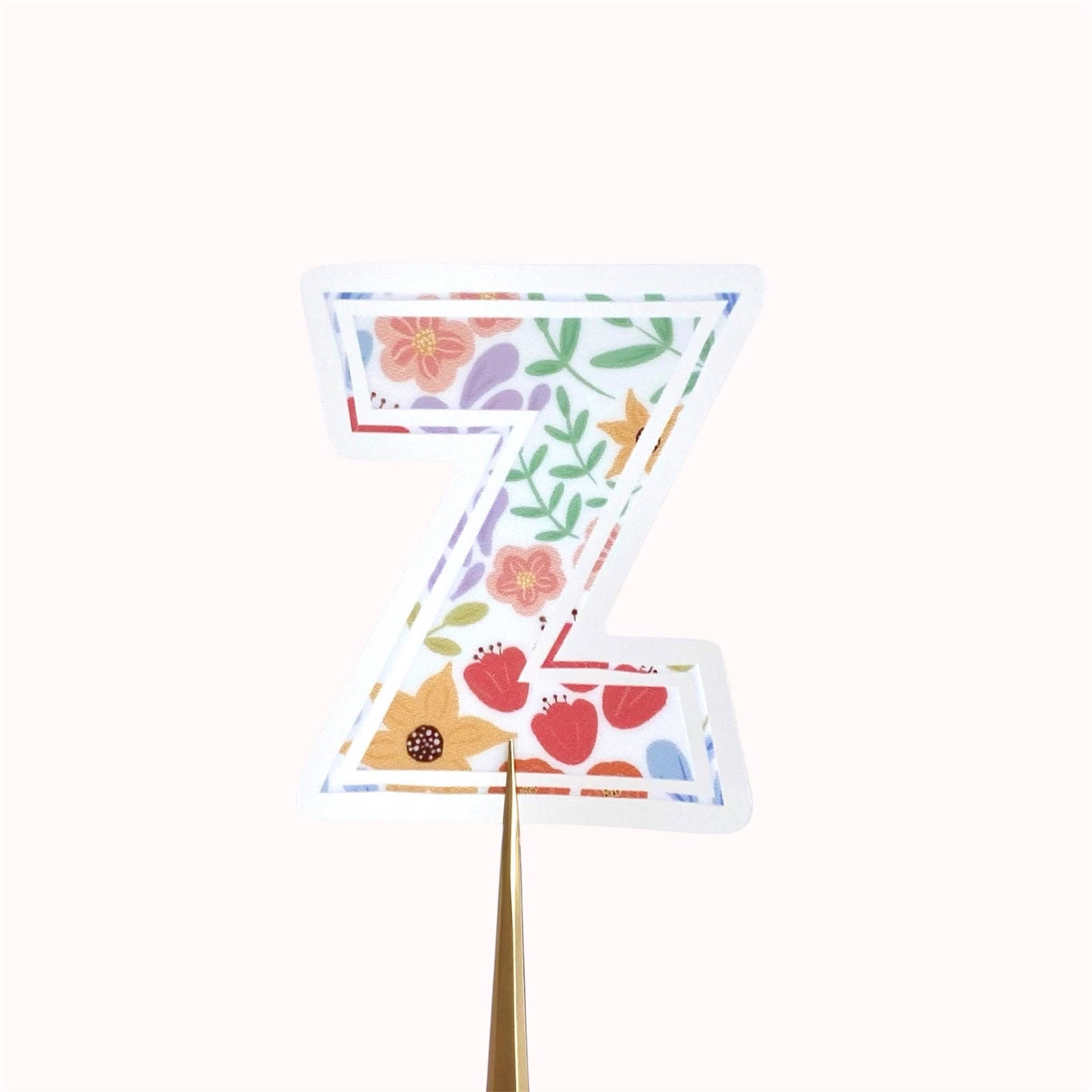 Decorative letter 'Z' sticker with floral patterns on a white background