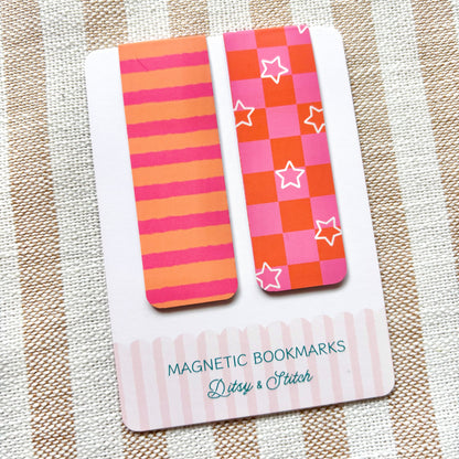 Two colourful magnetic bookmarks on a card with 'Ditsy & Stitch' branding, placed on a striped fabric background.